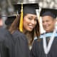 Adult college student smiling at her graduation ceremony.