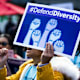 A demonstrator supporting Harvard University's admission process holds a sign that reads "Defend Diversity" during a protest