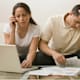 Hispanic couple having difficulty paying bills online