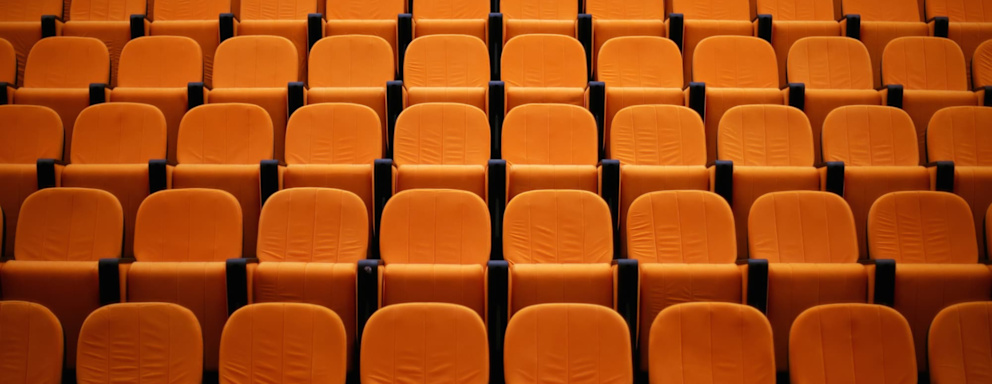 Empty seats in a college lecture hall.